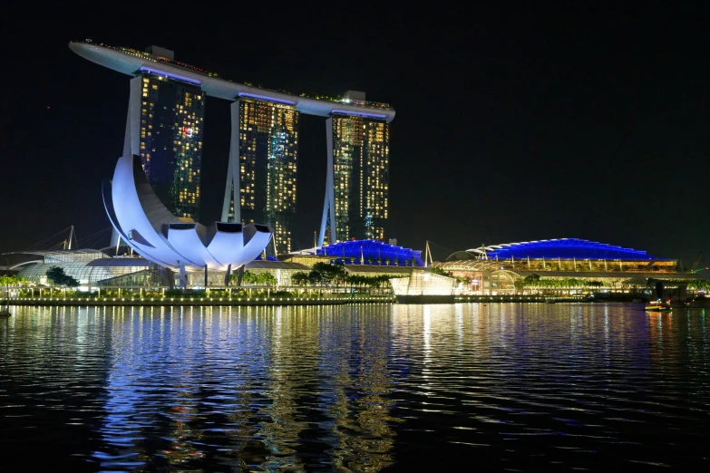 the marina by night with some lights reflecting in the water