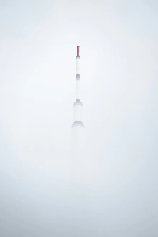 the view of a very tall building in the fog