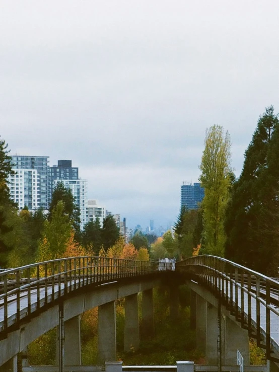 a bridge across some water near tall buildings