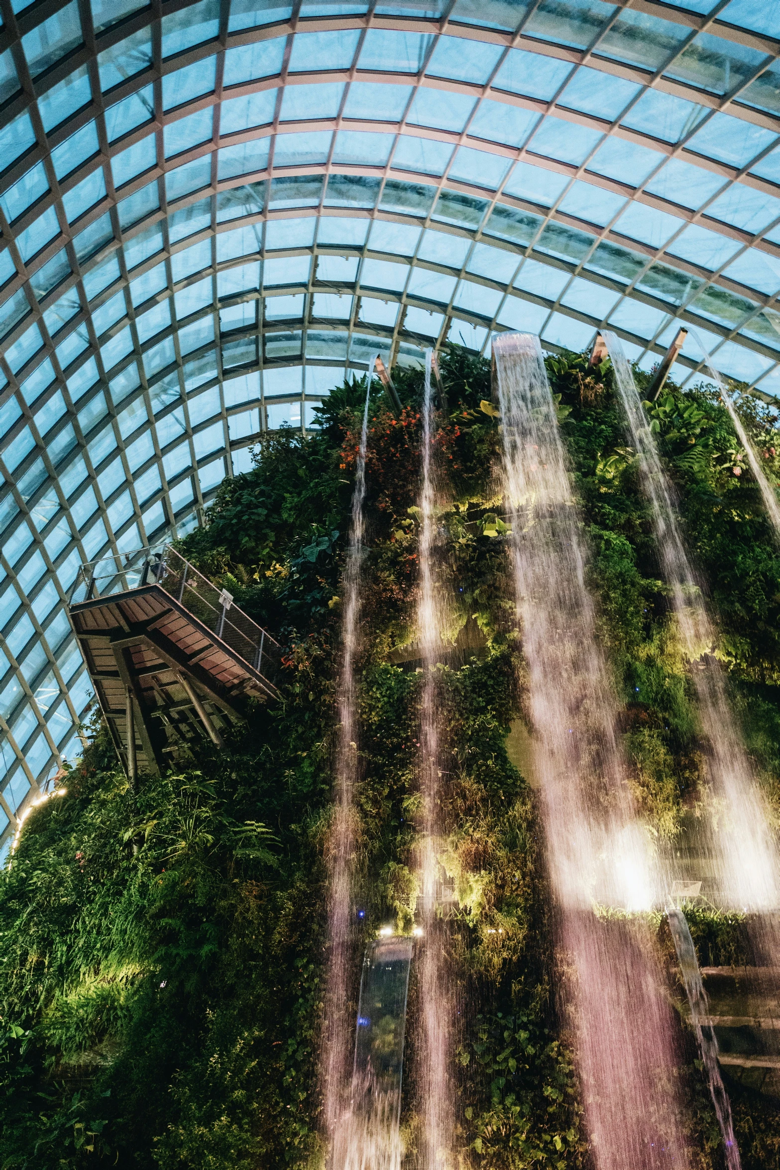 a huge waterfall inside of a glass building