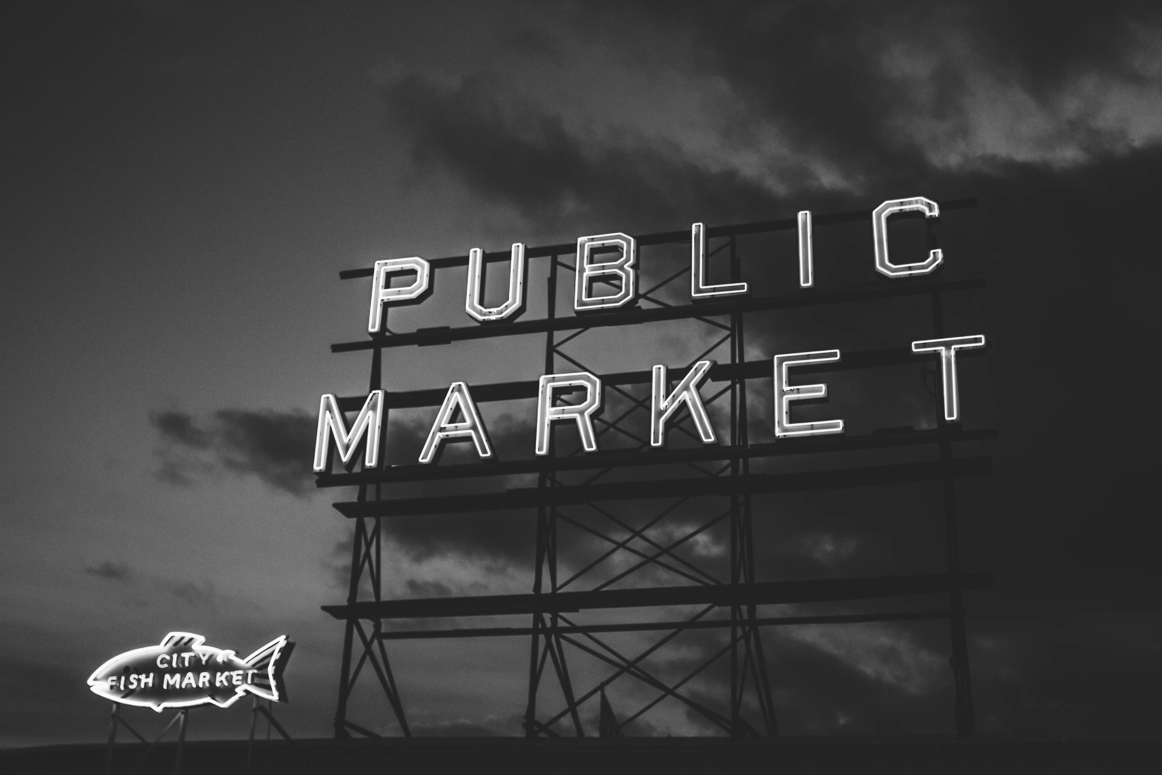 the neon sign above a building says public market