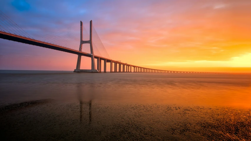 a large bridge stretching into the distance over the ocean