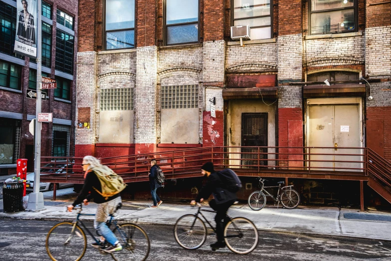 a couple of people riding bikes on a road