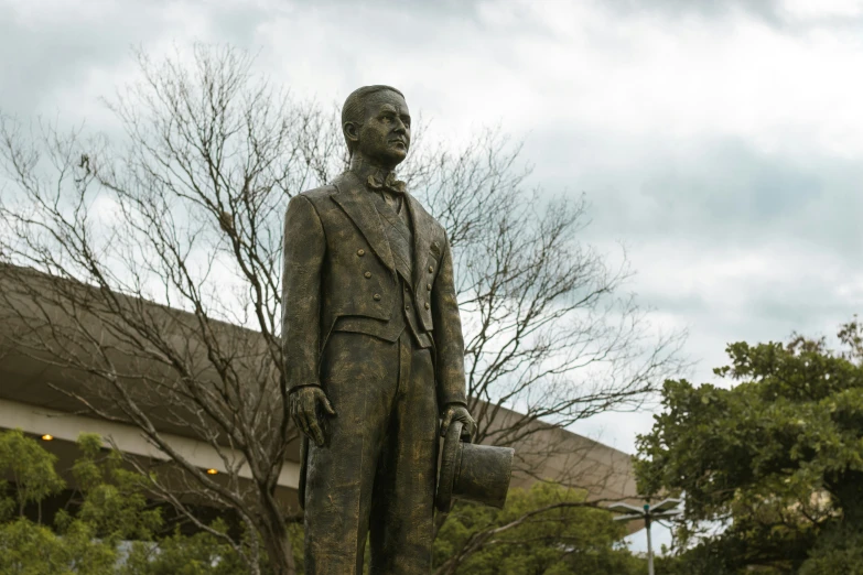 a statue with a hat and jacket on outside