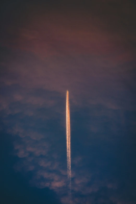 an airplane flies overhead in the night sky