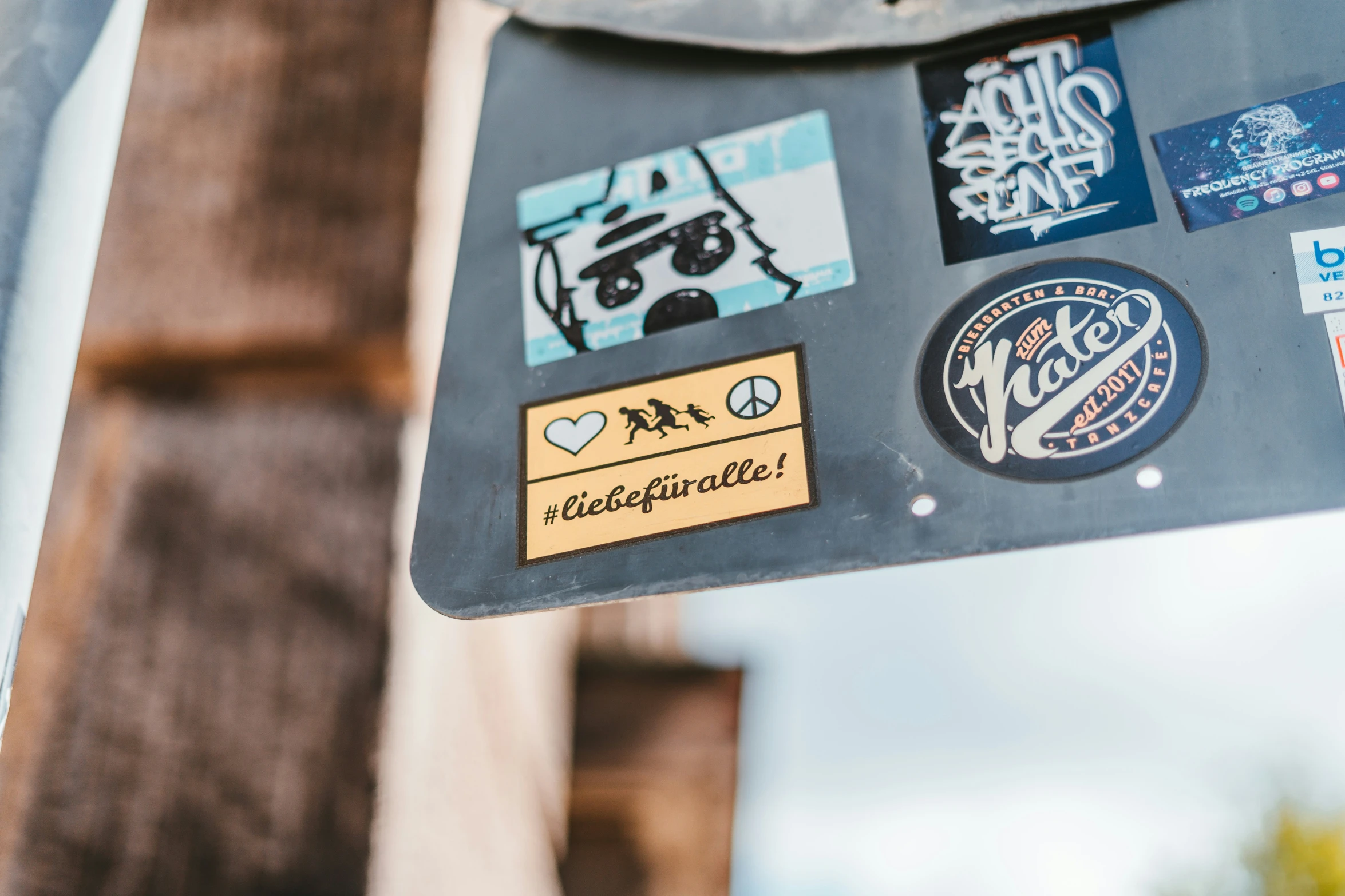 a sticker is attached to the back of a parking sign