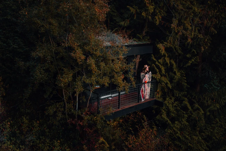 a woman in red walking across a bridge