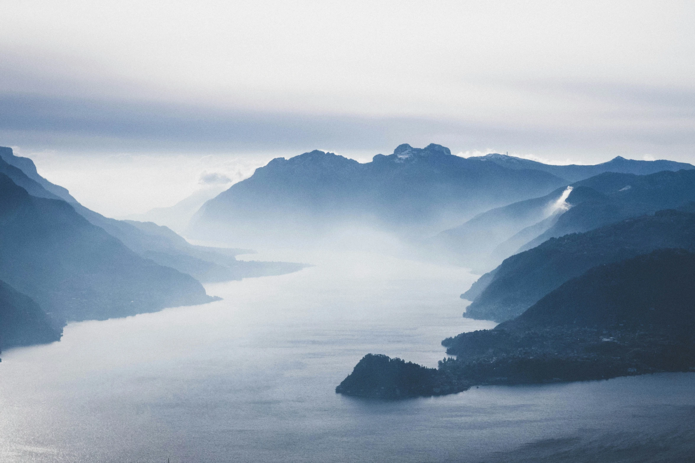 aerial s of foggy mountains and water at night