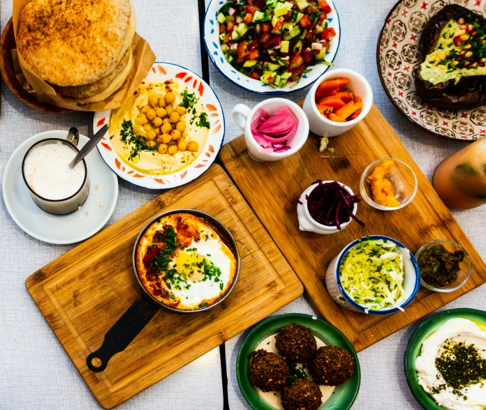 an array of baked goods on plates spread out on a table