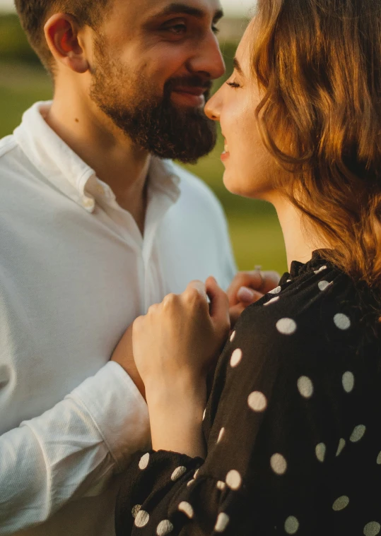 a couple smiles at each other while laughing