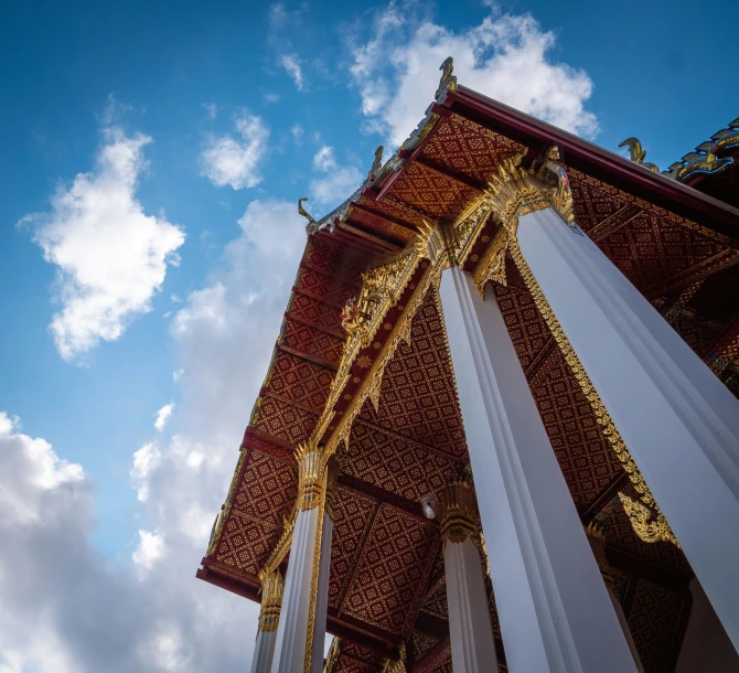 pillars against a sky with some clouds