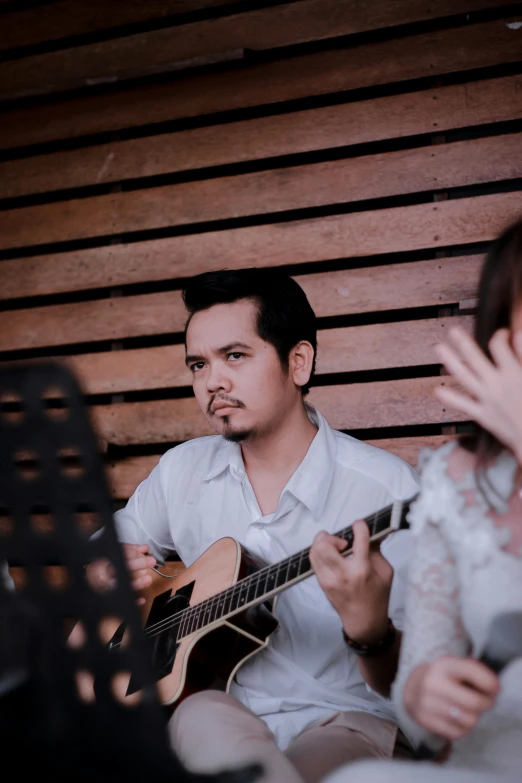 two people are playing instruments on a stage