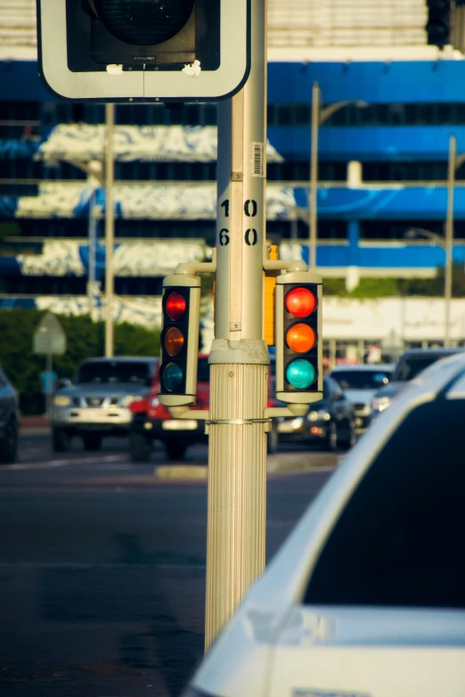 two stoplights hanging from a pole at an intersection