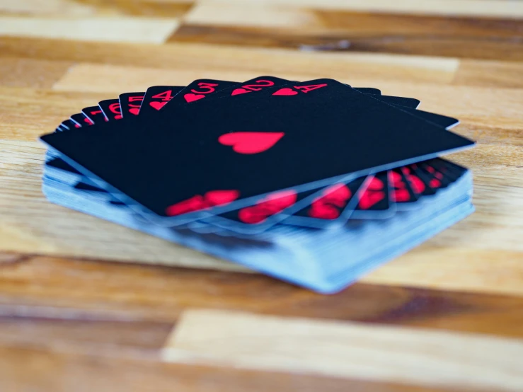 a stack of cards sitting on top of a wooden table