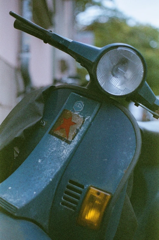 a blue scooter parked next to a building