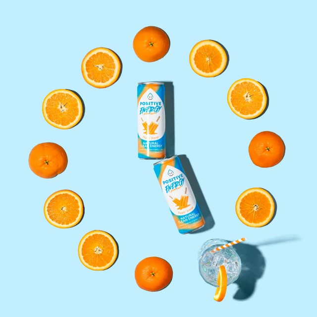 a tube of sunscreen with an orange and other oranges surrounding it