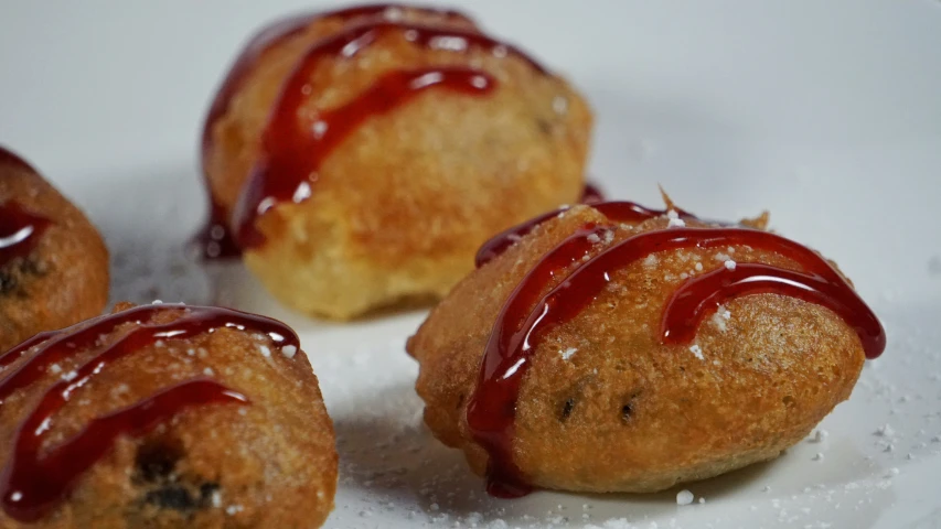 three small pastries with a drizzle of icing on them