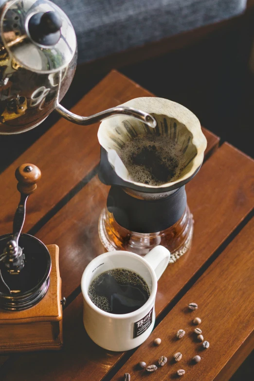 a coffee pot filled with coffee and a pour - driper next to it