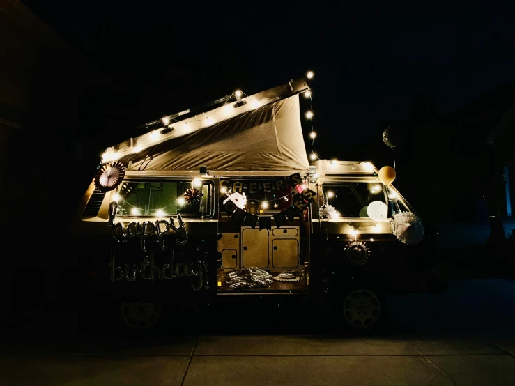 a large food truck has lights and some lights on it