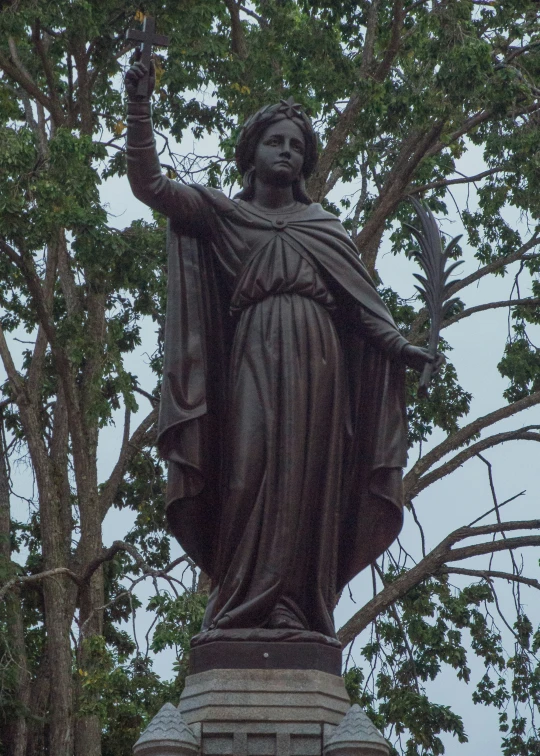 a large statue of a woman holding a ball is pictured here