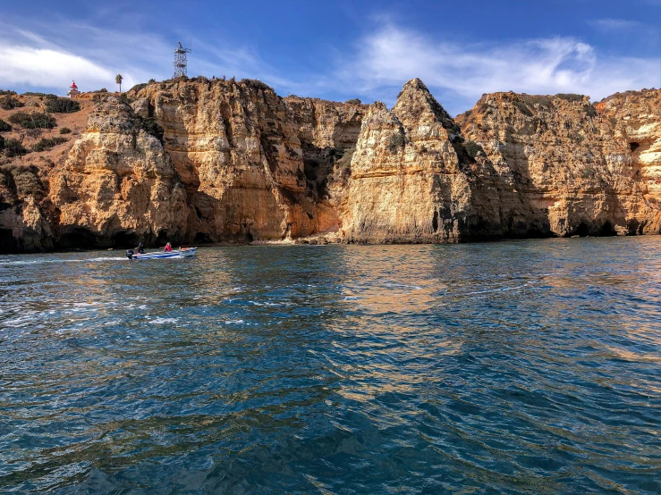 a mountain and body of water with boats in it