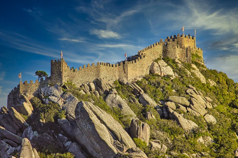 a castle like structure with many flags on top