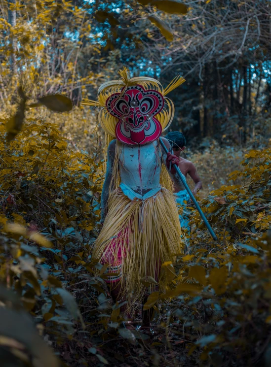 a woman in costume holding a stick and wearing a hat