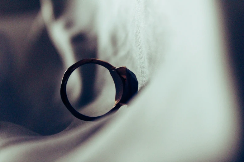 a black band with a wooden ring on a cloth