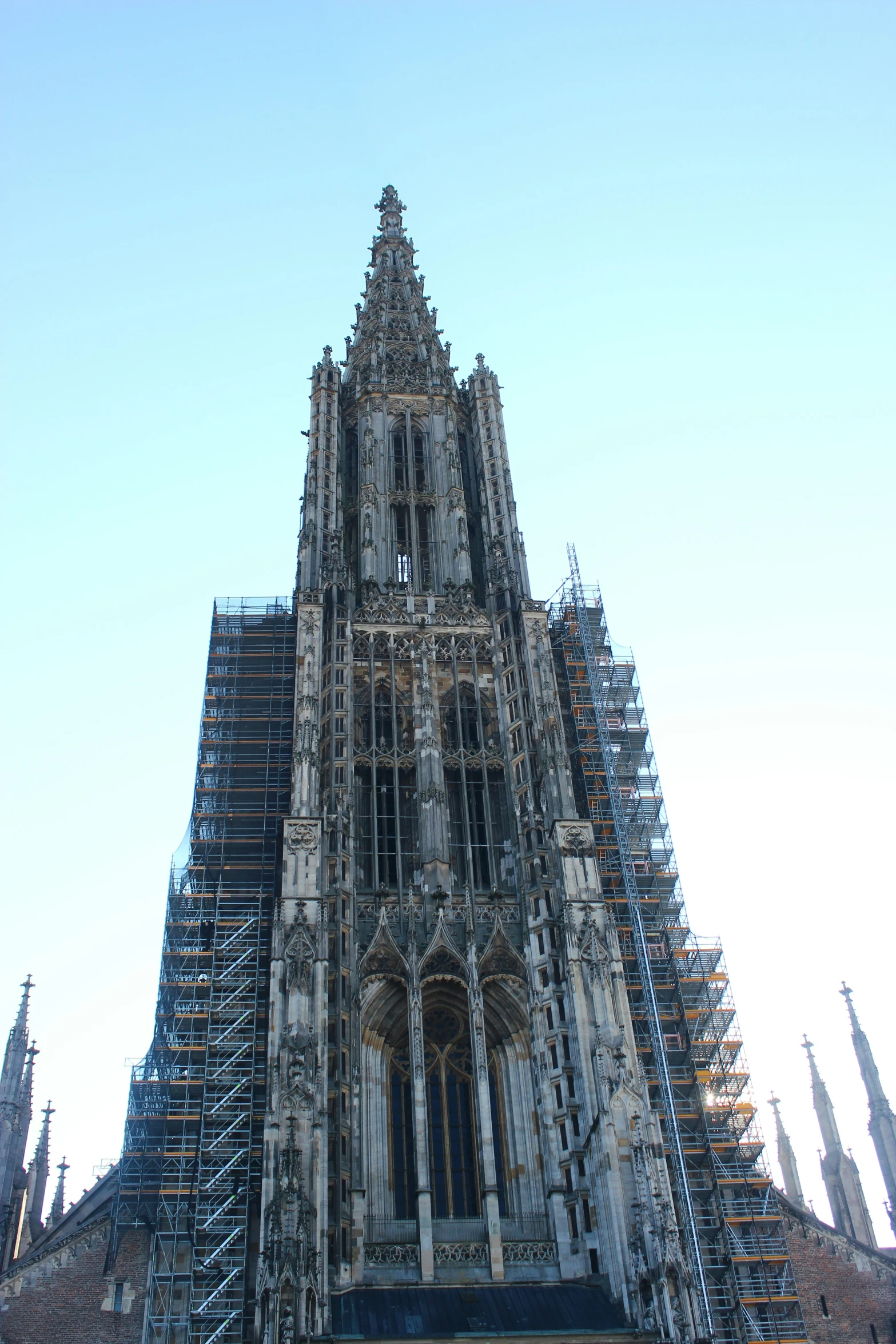 the large building is constructed with scaffolding around it