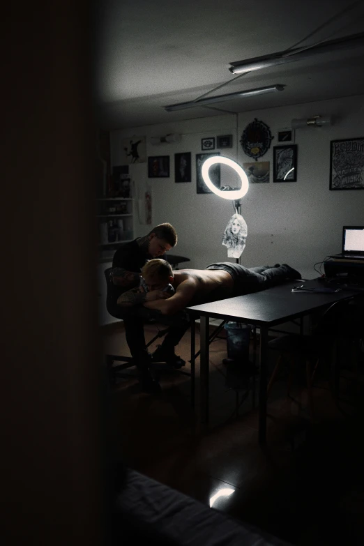 a man sitting at a table in a dimly lit room