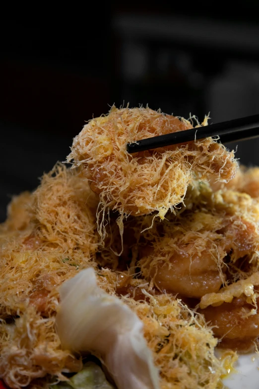 some kind of dish being cooked with chop sticks