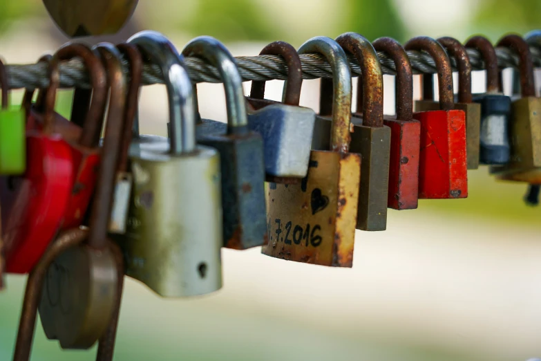 there are many padlocks hanging on the line