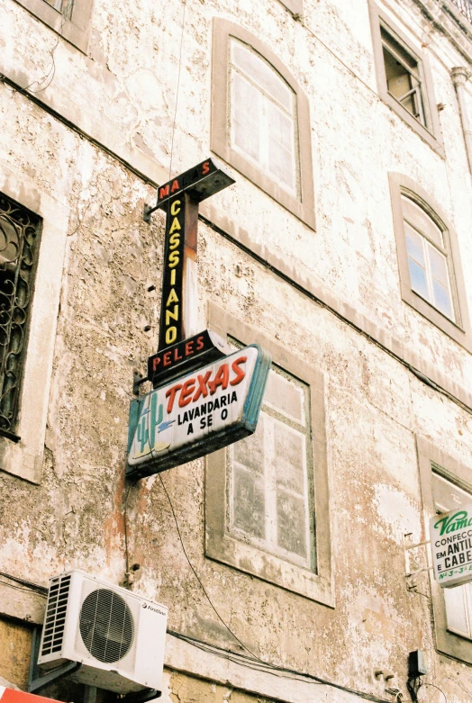 a large tan and black theater sign on the side of a building