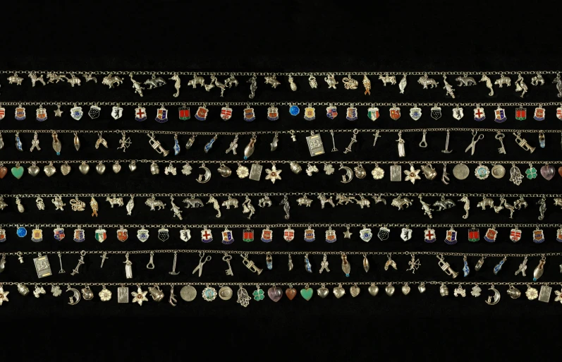 a series of elaborate beads and necklaces on a black background