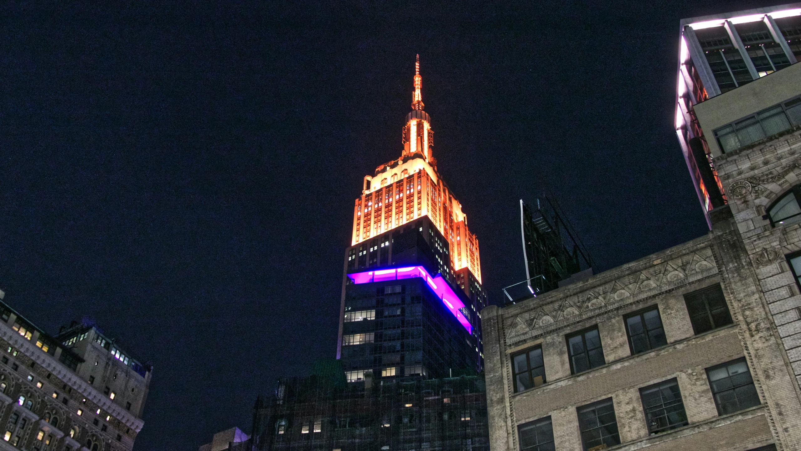 a skyscr is lit up at night with lights on it