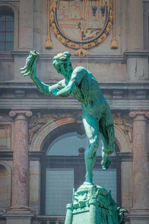 the statue is in front of a large building