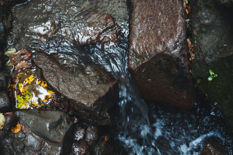 the small stream is running through some rocks