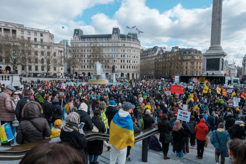 a group of people holding up signs and flags