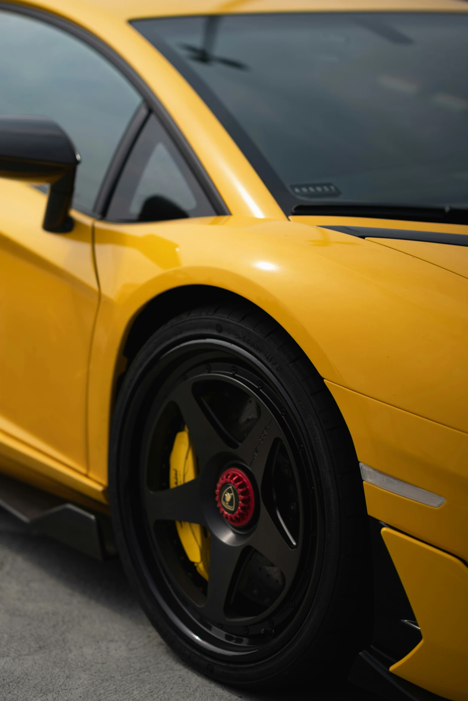 a yellow sport car parked on a concrete road