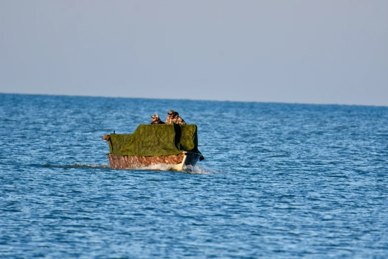 people riding in the boat that is anchored in the water