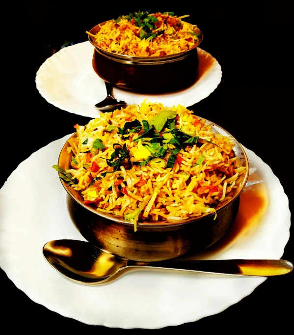 two dishes on a black table with spoons