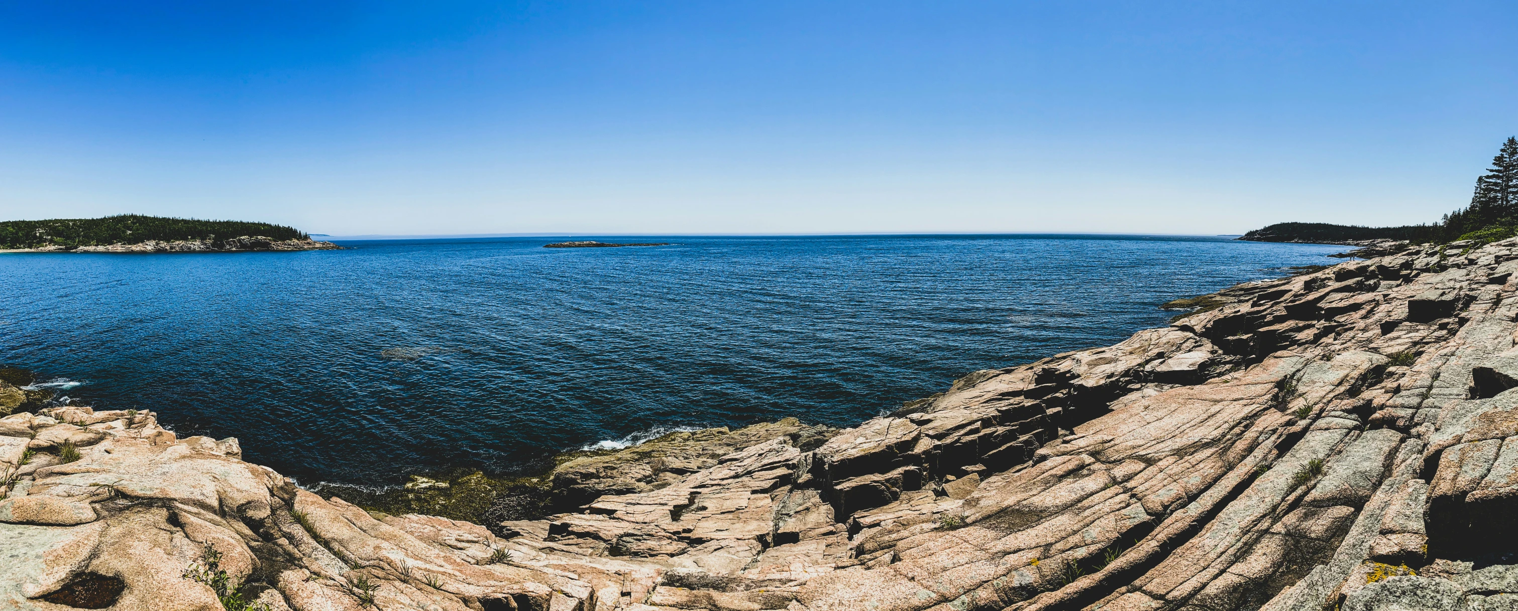 an overview of the sea from above with two small islands in the background