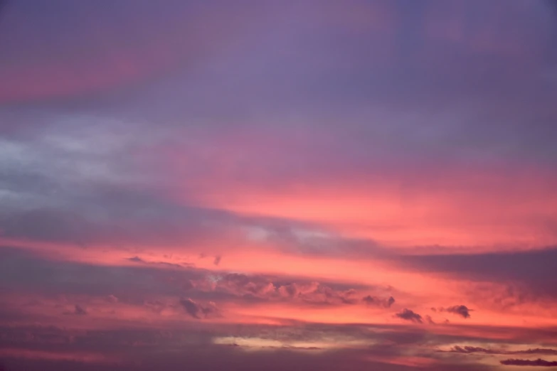 the orange clouds in the purple sky are lit up