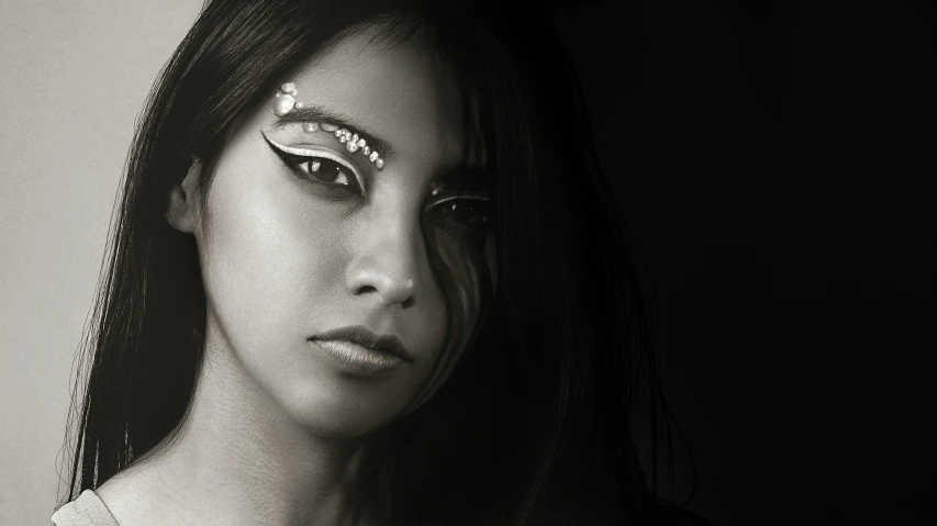 a girl with a pearled eye makeup poses for a black and white po