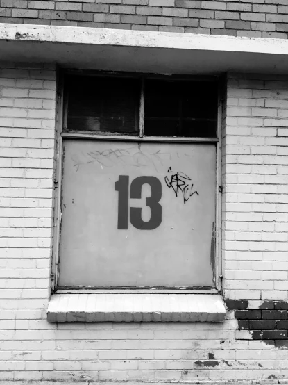 black and white pograph of graffiti in an empty window