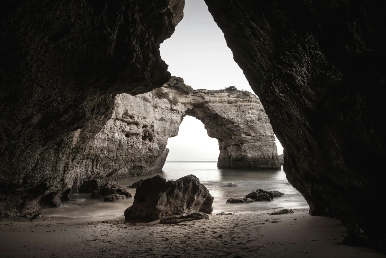 an old picture of rock formations at the beach