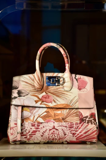 a floral purse with the handles rolled down