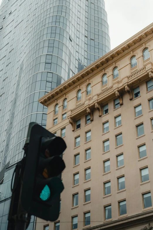 the building is tall and there is a traffic light