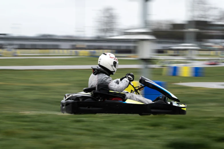 an image of person in the motion of a go kart