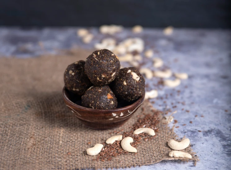 four raw chocolate balls sitting in a bowl